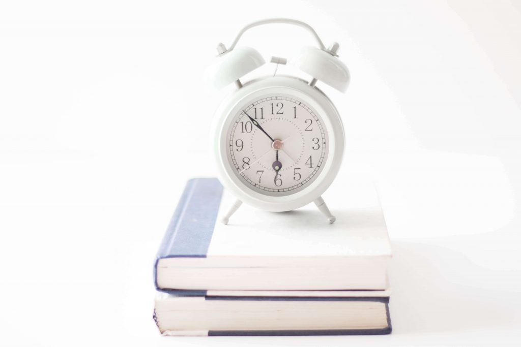 two books with alarm clock on top mom fail